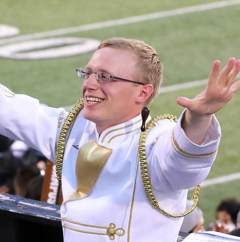 Trey Sims in white marching band uniform